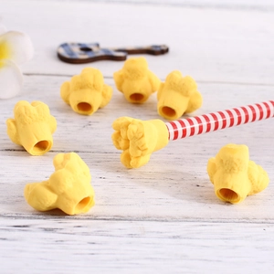 Macro detail of popcorn-shaped rubber erasers used as pencil toppers on wooden background