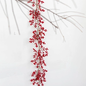 Artificial red berry garland for Christmas home decor with dense berries and white background