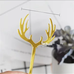 Macro detail of a 5.6cm wide golden mirror acrylic reindeer antler cake topper decoration