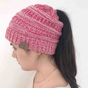 Pink and white knit ponytail beanie hat for women featuring a functional top opening