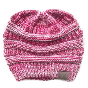 Detail of pink and white knitted ponytail beanie showing soft yarn texture and top hole