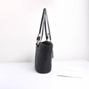 Fashionable black straw tote bag with striped handles and leather straps for beach holidays