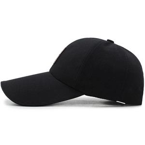 Classic black cotton baseball cap with stylish side leather patch on white background