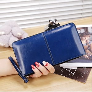 Close-up of dark blue long zipper wallet with wristlet and vertical stitching detail