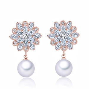 Elegant rose gold floral earrings with sparkling cubic zirconia and white hanging pearls