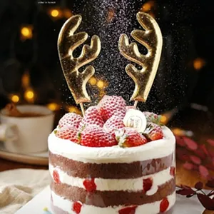 Detailed view of golden reindeer horn cake toppers with a textured finish on a festive cake