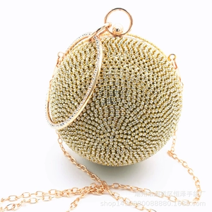 Detailed view of spherical rhinestone evening bag with round handle and gold metal chain