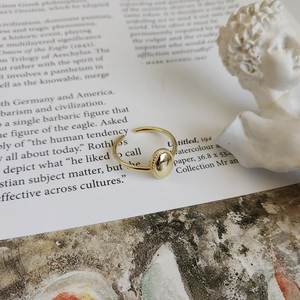 Macro shot of gold adjustable ring with oval relief and vintage textured edges
