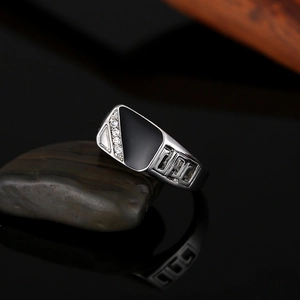 Detail of silver men's ring with black enamel inlay and side crystal rhinestones