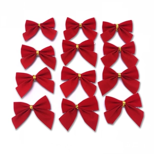 Set of 12 red flocked Christmas tree bows with gold ties on a plain white background