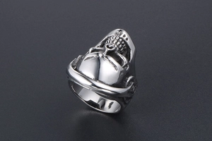 Macro detail of gothic skull ring in silver metal with punk rock headphone design