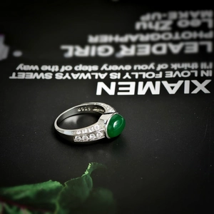 Vintage silver ring featuring an oval emerald stone with micro-pave cubic zirconia accents