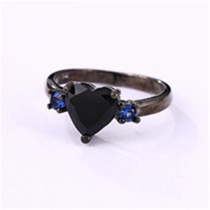 Macro shot of black heart-shaped stone and blue zircon accents on gothic metal band