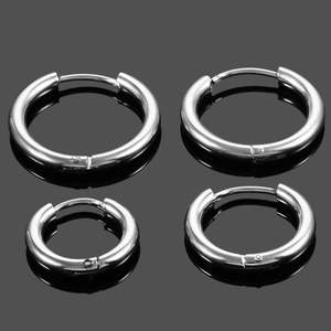 Macro shot of two pairs of silver stainless steel hoop earrings in different sizes