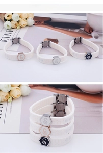 White silicone sport bracelet with honeycomb texture and metallic hexagonal g-logo detail