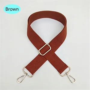 Close-up of brown adjustable woven replacement shoulder strap with gold metal hooks