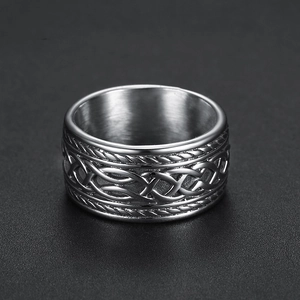 Detail view of vintage Celtic knot embossed pattern on wide stainless steel ring