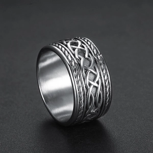 Detail of Celtic knot pattern on heavy stainless steel ring with brushed metal texture