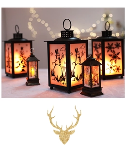 Close-up of LED Christmas lanterns with snowman and Santa silhouettes in warm light