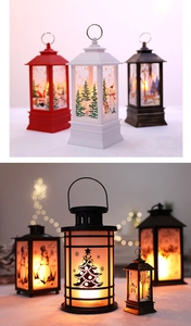Close-up of LED Christmas lanterns with Santa and reindeer motifs in warm glowing light