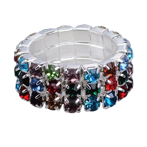 Macro shot of silver elastic ring featuring three rows of colorful crystals and rhinestones