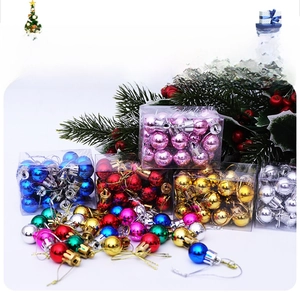 Detail of colorful shiny mini Christmas tree ornaments with hanging strings in a clear box
