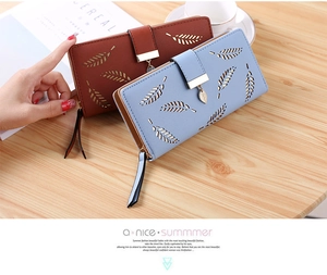 Detail of long wallets with hollow leaf patterns, metal leaf zipper, and large capacity