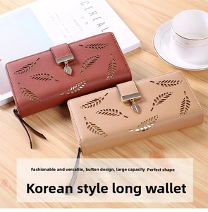 Detail of PU leather wallets featuring hollow leaf patterns and metal pendants