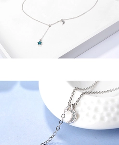 Macro shot of silver moon and blue star pendant necklace with crystal rhinestones