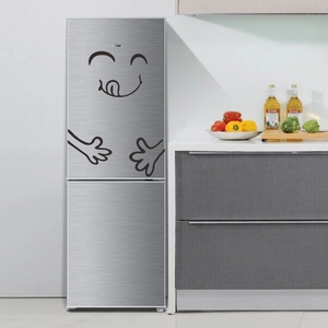 Playful black cartoon smiling face fridge stickers on a brushed silver refrigerator