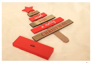 Detailed flat lay of DIY wooden Christmas tree blocks with Merry Christmas engraving