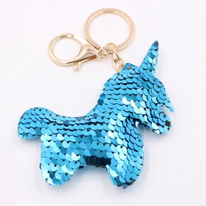 Blue sequin unicorn keychain with gold metallic ring on white background