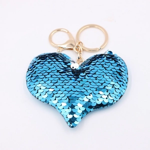 Close-up of heart-shaped blue sequin keychain with gold metal ring and lobster clasp