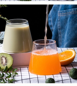 Detail of pouring juice into a Mount Fuji shaped glass on a fresh dining table setup