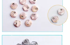 Detailed view of hexagonal marble nail charms with small diamonds for DIY nail art