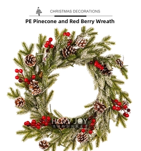 Close-up of frosted PE pine needles with red berries and pine cones on Christmas wreath