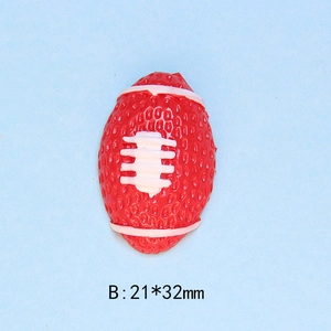 Detailed view of red resin rugby ball flatback with white stitching and size dimensions