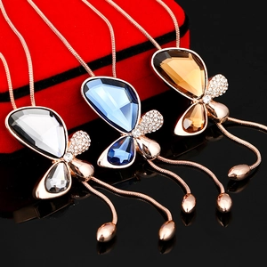 Close-up of butterfly crystal pendants in clear, blue, and amber colors with rhinestones