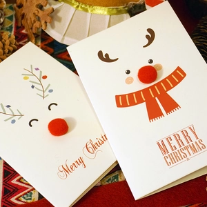 Christmas greeting cards with creative reindeer designs and 3D plush ball noses on white cardstock