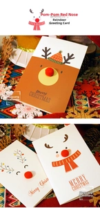 Close-up of reindeer Christmas card with 3D red pompom nose and festive snowflake decor
