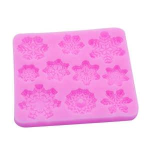 Pink silicone mold featuring various snowflake shapes for Christmas fondant and chocolate DIY