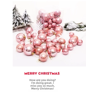 Pink pearlescent Christmas ball ornaments set with pine branches on white background
