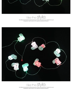 Detail view of colorful LED Christmas fairy lights with mini boot shaped ornaments