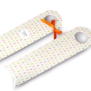 Detail of Korean style paper cookie box with colorful teardrop pattern and orange ribbon