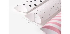 Detail showing 8cm by 3cm dimensions of colorful polka dot and striped pillow boxes