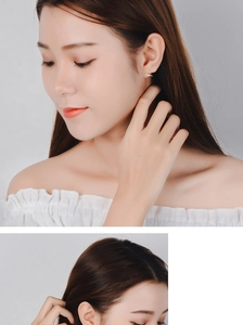 Close-up of model wearing colorful enamel bird earrings with pastel gradient details