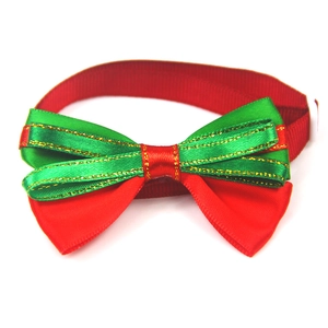 Detail of Christmas pet bowtie with red green ribbon and gold thread accents