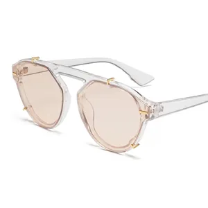 Stylish unisex vintage sunglasses with clear peach lenses and gold rivet accents