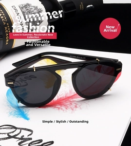 Detail of square black sunglasses with gold rivet accents and polarized dark lenses