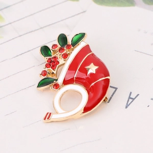 Detail of a Christmas cornucopia brooch with red enamel, rhinestones and golden star